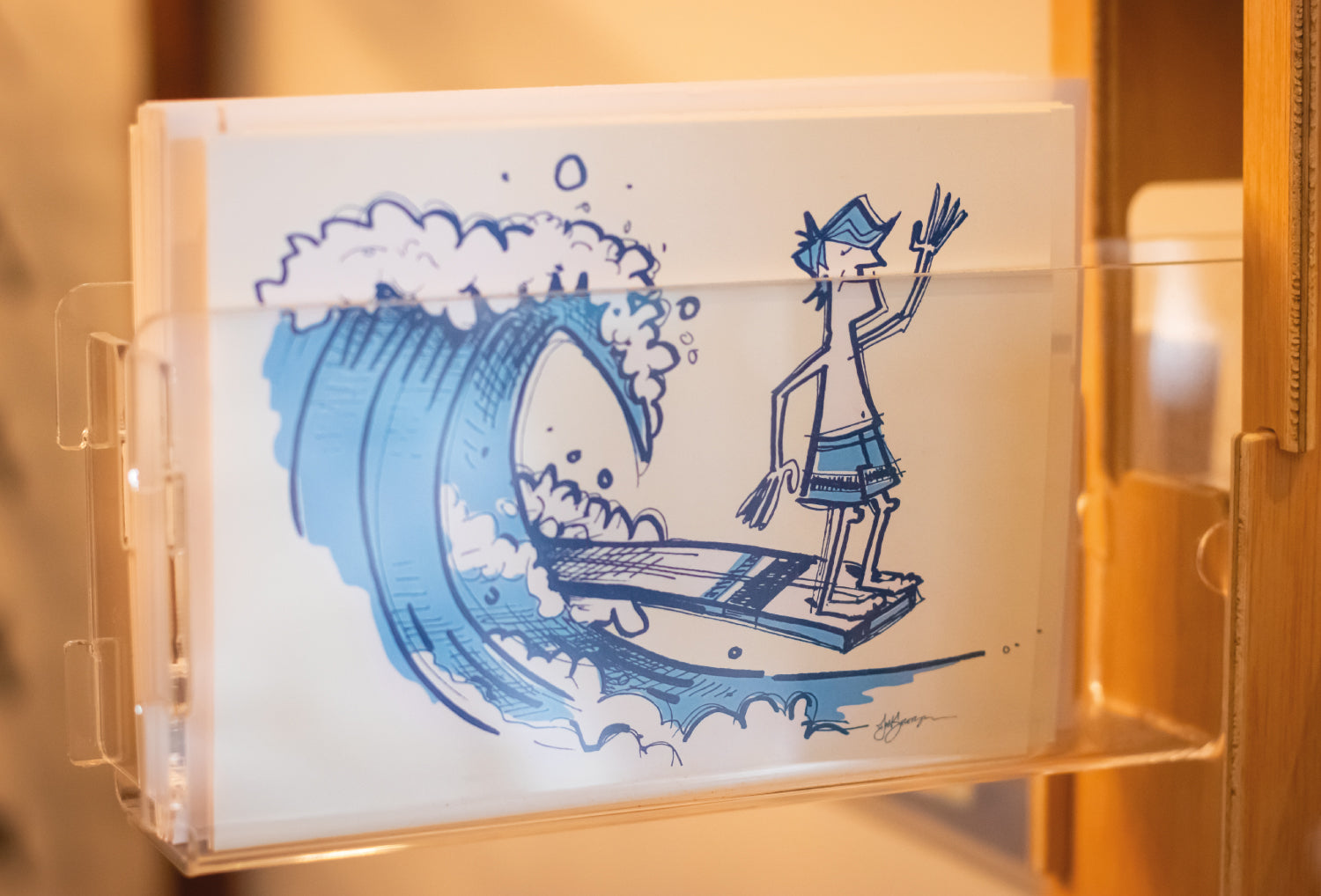 Cards & prints header. Two surfers paddling out with wave coming in.
