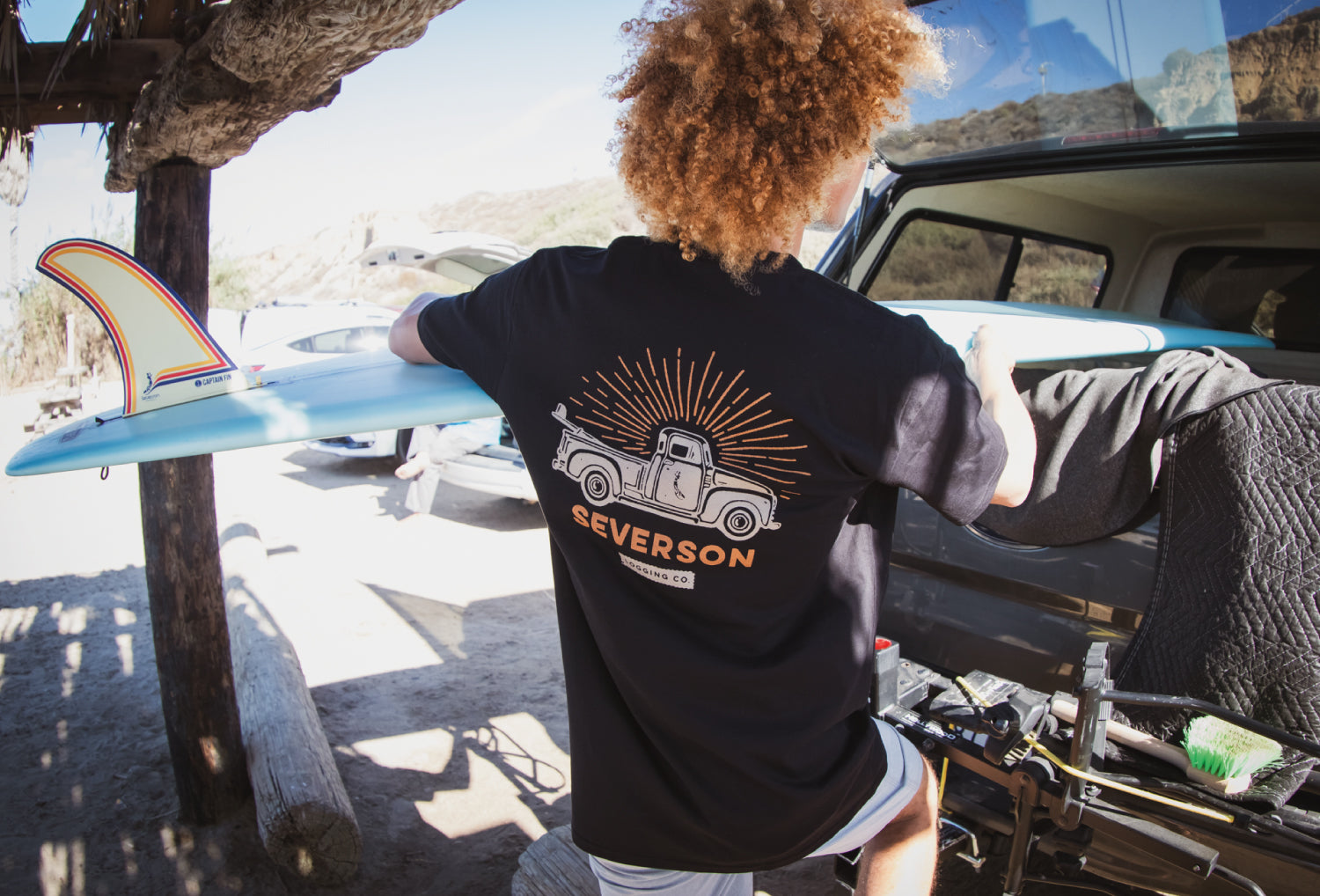 Man at beach with surfboard checking out the waves.