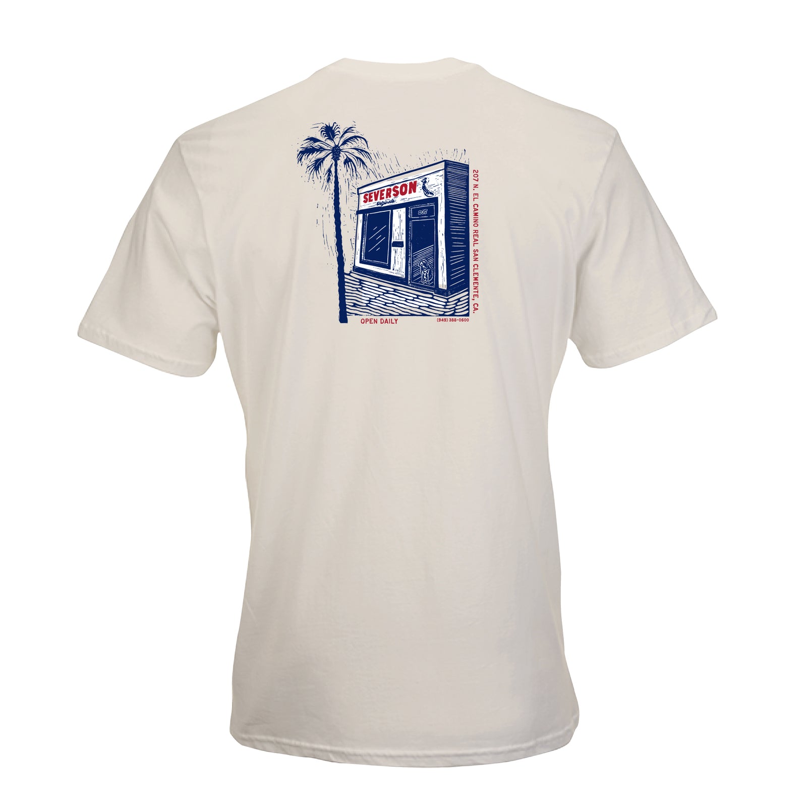 Back of mens t-shirt in Vintage white. Back design in red, white and blue image of Severson store in San Clemente, with palm tree and dog in doorway. also shows shop address in smaller text