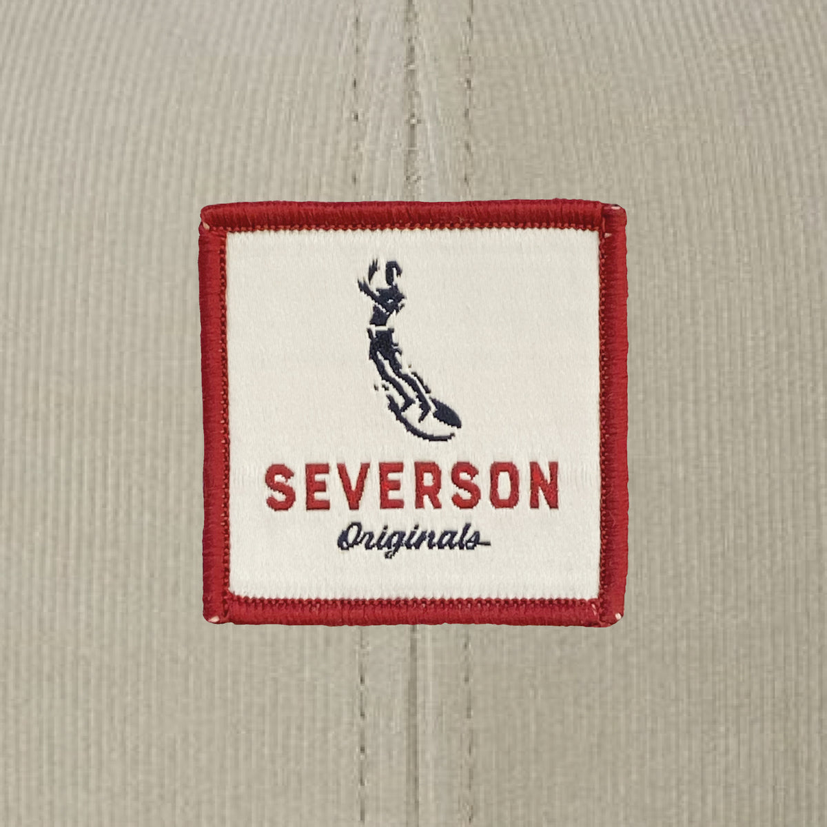 Close up view of Severson Originals logo in red, white and blue square patch.